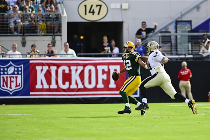 Green Bay Packers quarterback Aaron Rodgers (12) scrambles as New Orleans Saints defensive end Cameron Jordan (94) pressures. Mandatory Credit: Tommy Gilligan-USA TODAY Sports
